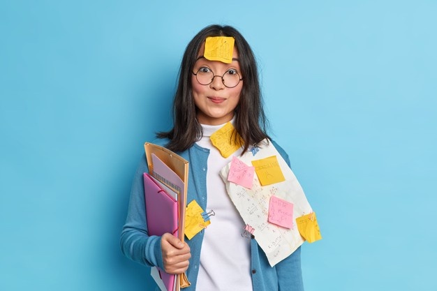 pretty-schoolgirl-prepares-math-test-crams-material-has-sticker-forehead-forget-necessary-information-busy-studying_273609-46313